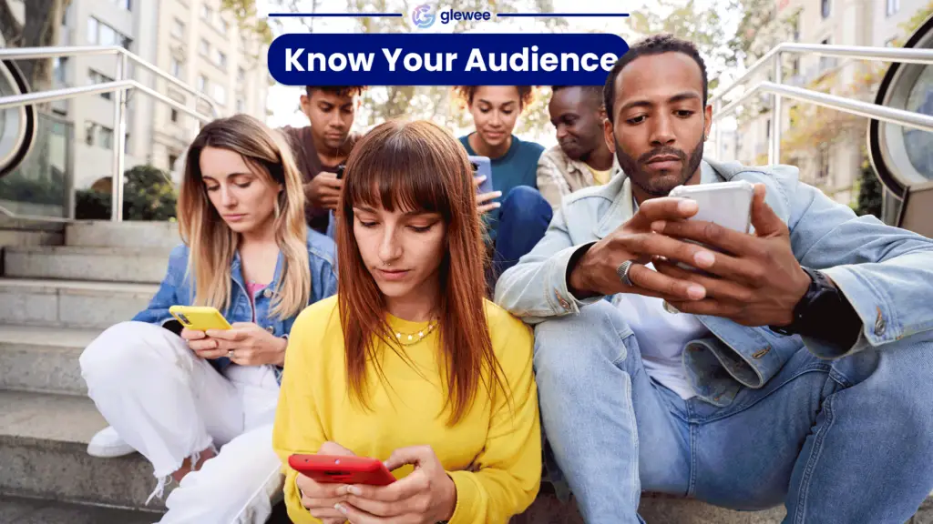 Diverse group of people sitting on steps looking at their phones, all wearing different color shirts with different color iPhones