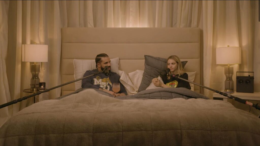 Bobbi Althoff and Drake sitting in his bed during the podcast.