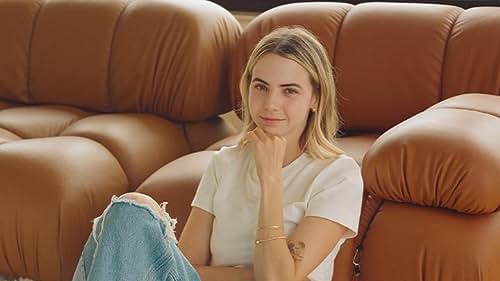 Bobbi Althoff sitting at the end of a couch.