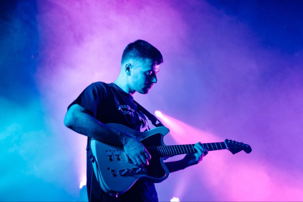 musician playing the guitar on stage
