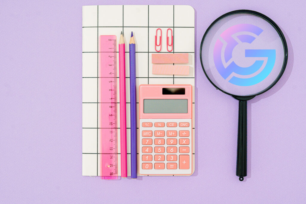 Flatlay of a notebook, a ruler, a calculator, paper clips, sticky notes, and a magnifying glass with the Glewee logo